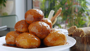 Kuih keria are Malaysian deep-fried doughnuts that are made from sweet potatoes. After they are steamed and mashed, the potatoes are combined with flour to form a pliable dough that is then shaped into doughnut rings.